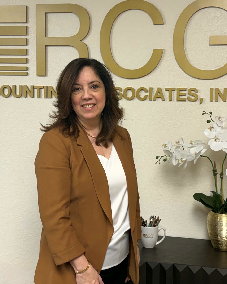 Deborah Gonzalez, EA, standing beside the RCG Accounting & Associates sign in Pembroke Pines